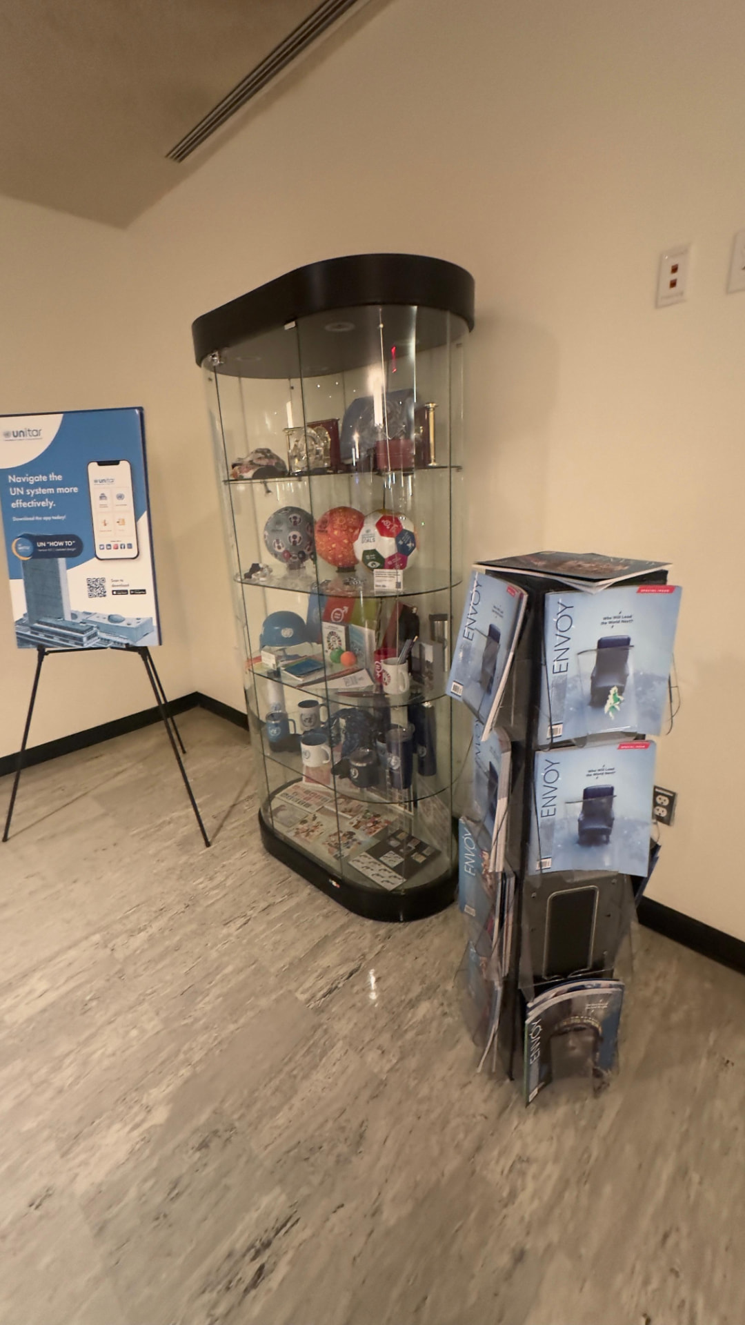 Envoy Magazine special issue displayed on a rack at United Nations Headquarters.